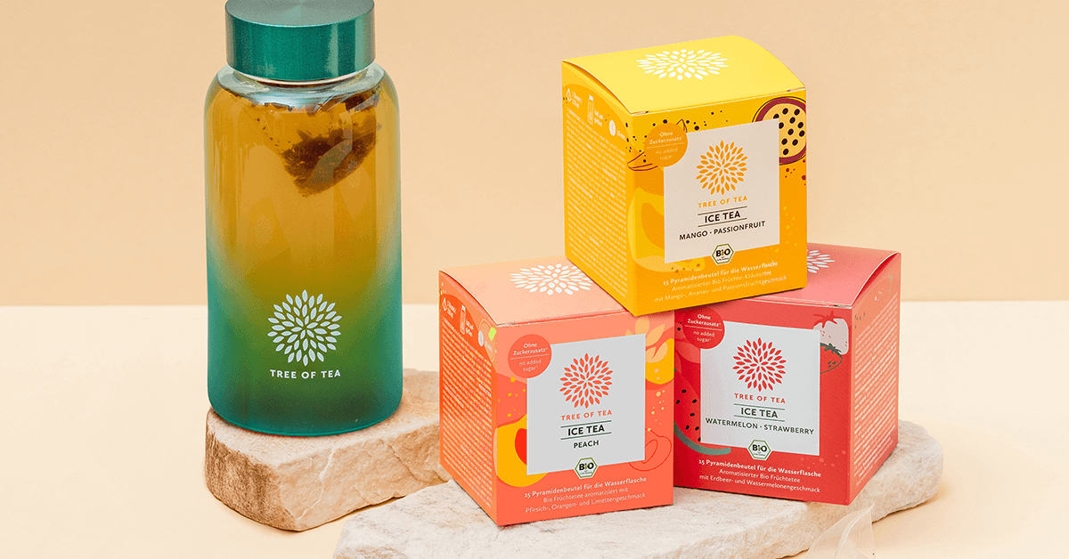 Tree of Tea Ice Tea Starter Set mit Mango Passionfruit, Peach, Watermelon Strawberry und türkiser Ice Tea Bottle auf einer Steinplatte vor minimalistischem Hintergrund.