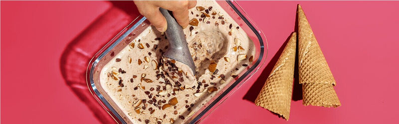 Bananen Mandel Nicecream in einem Glasbehälter und Waffeln daneben