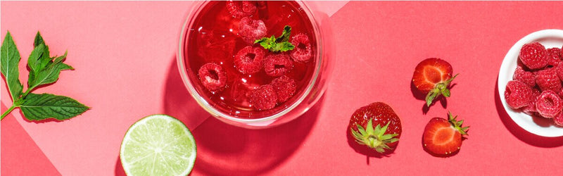 Minty Ruby in einem Glas mit Himbeeren und einer halben Limetten