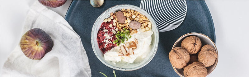 Winterliches Quark-Himbeerkompott mit Adventsmüsli auf einem Teller