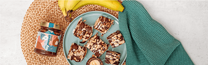 Schoko Bananen Sushi auf einem Teller mit Banane daneben