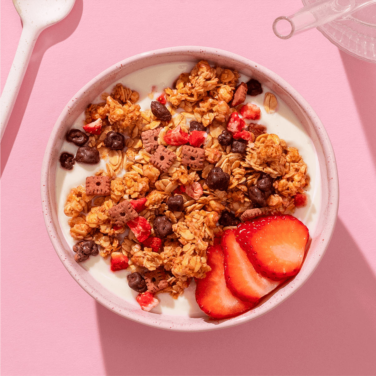 mymuesli Bio Strawberry Choco Crunchy Granola in Schale mit frischen Erdbeeren und Joghurt